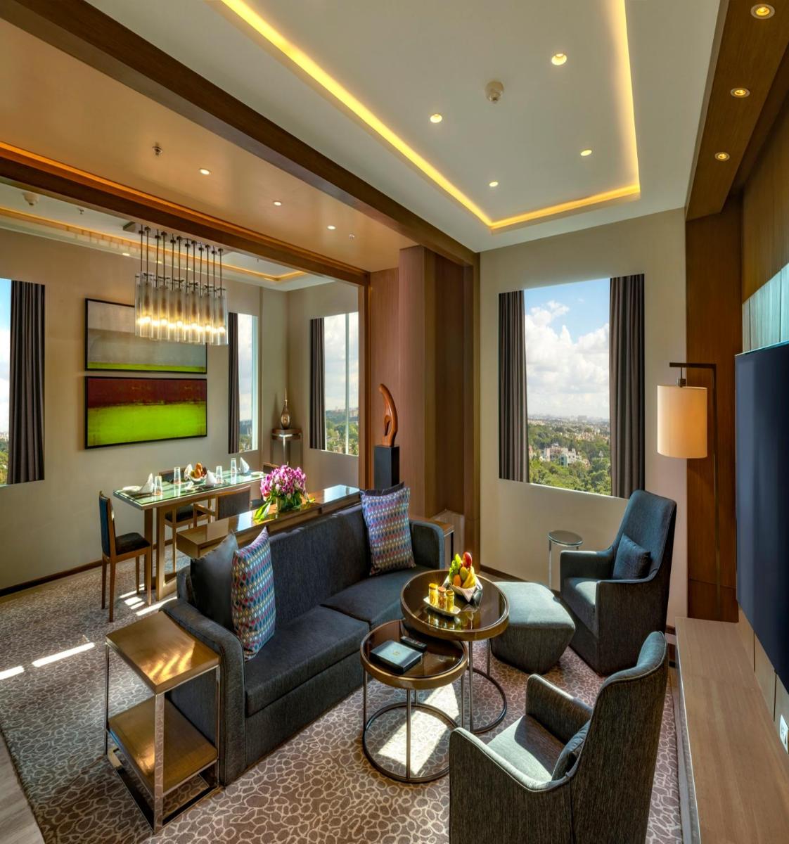 a living room with a couch and chairs and a table at Welcomhotel by ITC Hotels, Richmond Road, Bengaluru in Bengaluru
