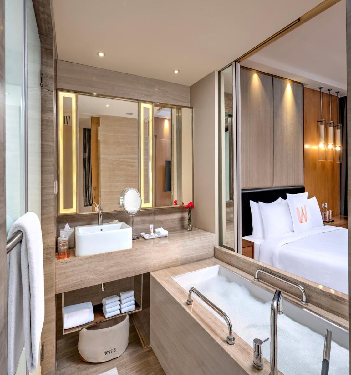 a bathroom with a bed and a sink and a tub at Welcomhotel by ITC Hotels, Richmond Road, Bengaluru in Bengaluru