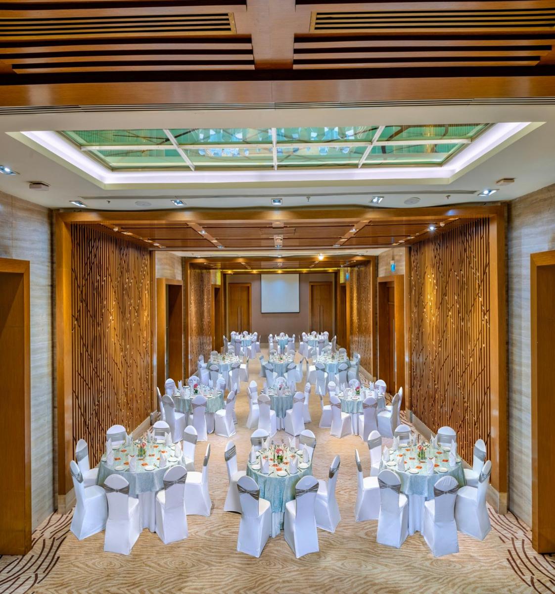 a room filled with tables and chairs in a room at Welcomhotel by ITC Hotels, Richmond Road, Bengaluru in Bengaluru