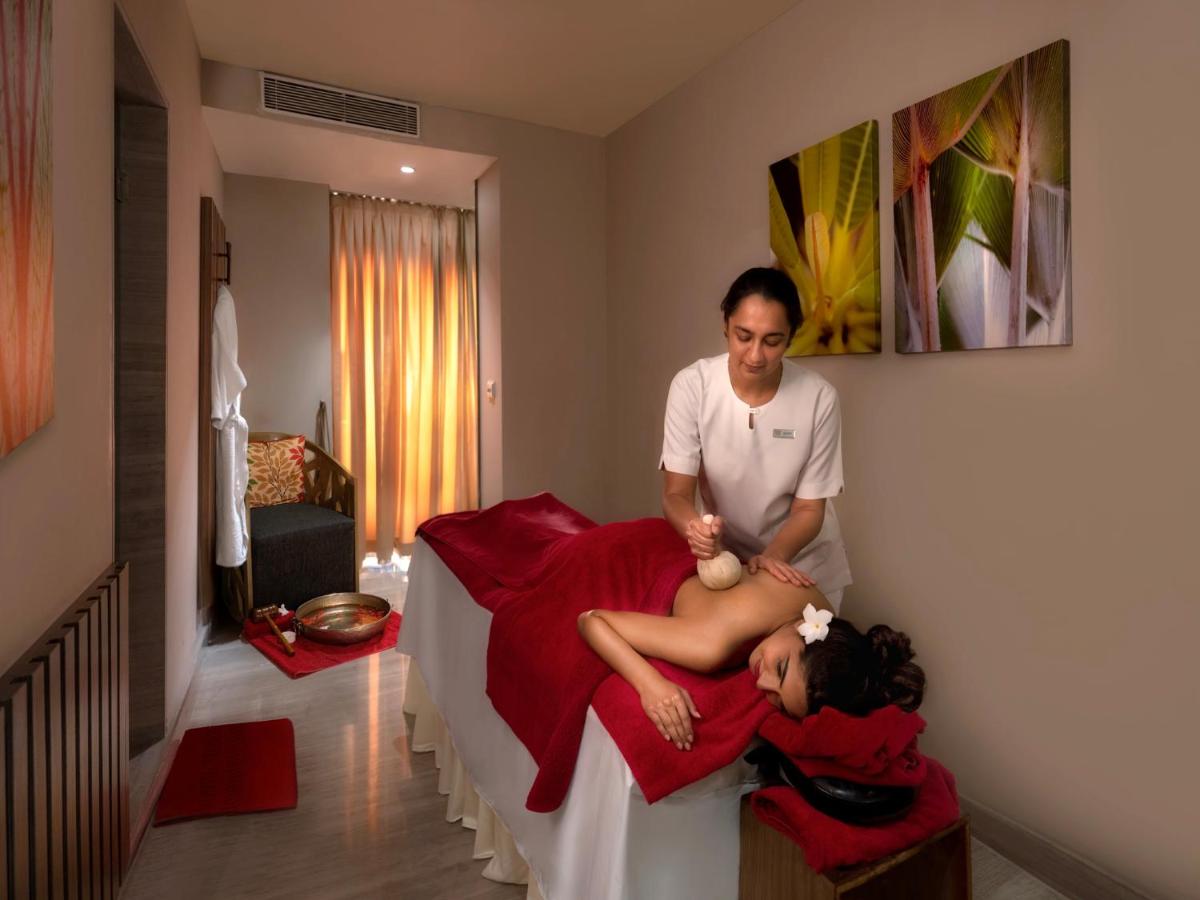 a man standing next to a woman on a bed at Welcomhotel by ITC Hotels, Richmond Road, Bengaluru in Bengaluru