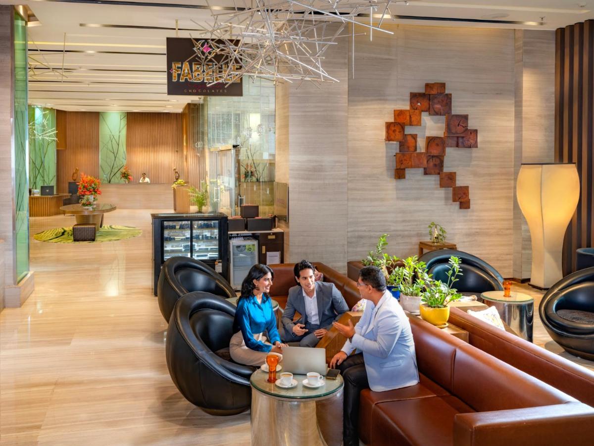 a group of people sitting on couches in a lobby at Welcomhotel by ITC Hotels, Richmond Road, Bengaluru in Bengaluru