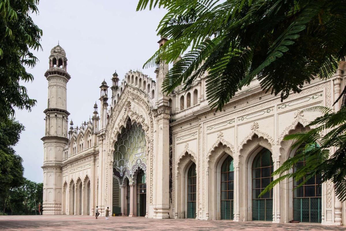 a building with a mosque with a clock tower at Hyatt Regency Lucknow Gomti Nagar in Lucknow