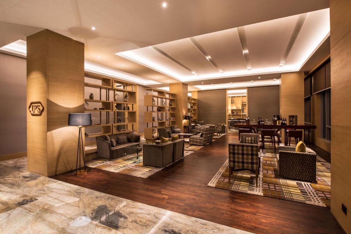 a lobby with couches and chairs and a table at Hyatt Regency Lucknow Gomti Nagar in Lucknow