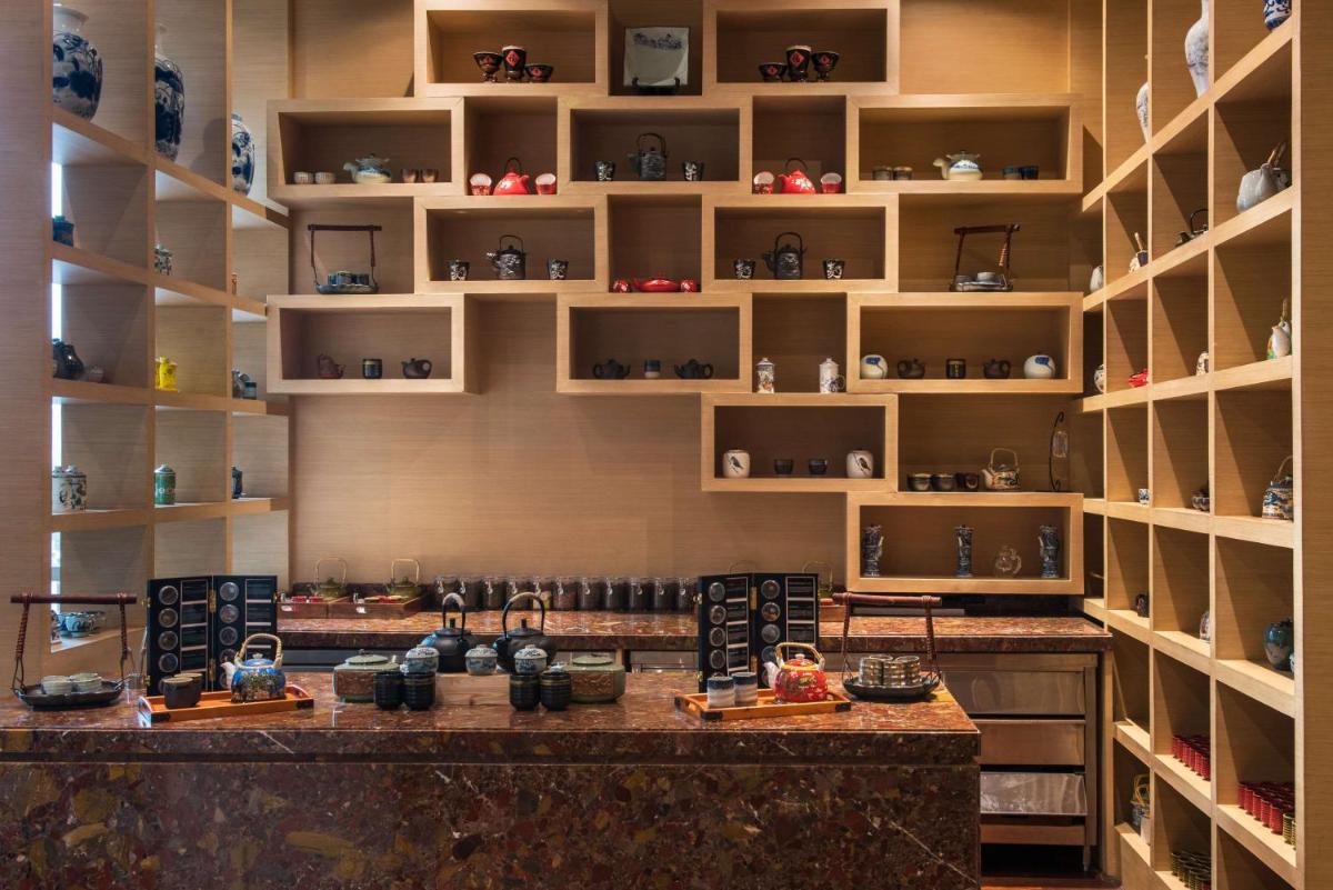 a room with a counter with vases on shelves at Hyatt Regency Lucknow Gomti Nagar in Lucknow