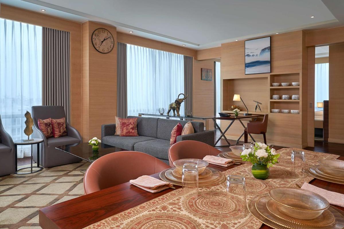 a living room with a table and a couch at Hyatt Regency Lucknow Gomti Nagar in Lucknow