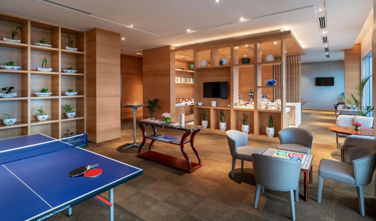 a room with a ping pong table and chairs at Hyatt Regency Lucknow Gomti Nagar in Lucknow