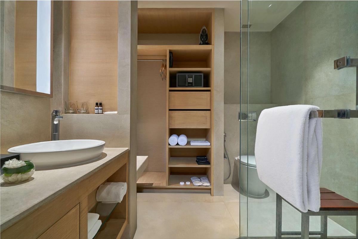 a bathroom with a sink and a glass shower at Hyatt Regency Lucknow Gomti Nagar in Lucknow