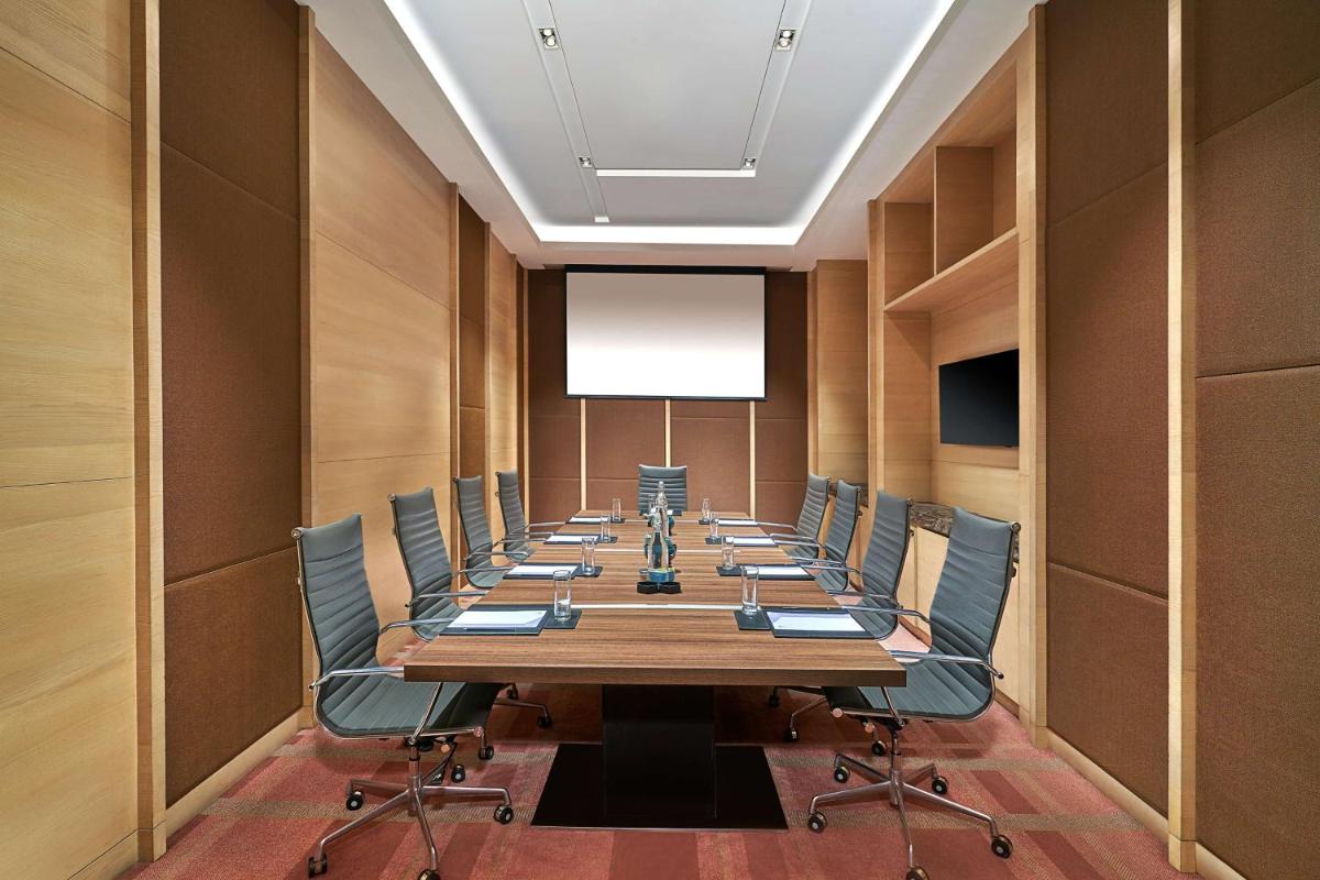 a conference room with a long table and chairs at Hyatt Regency Lucknow Gomti Nagar in Lucknow
