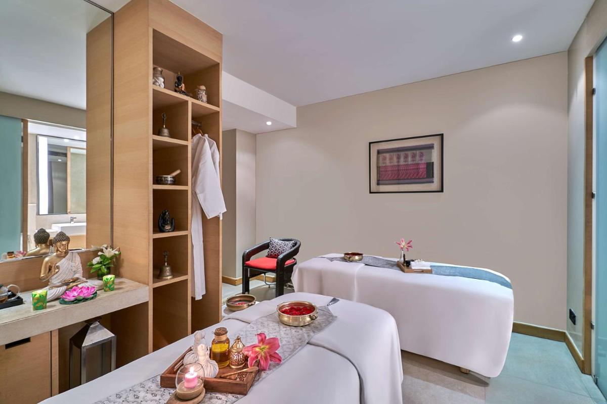 a room with a bed and a table in a room at Hyatt Regency Lucknow Gomti Nagar in Lucknow