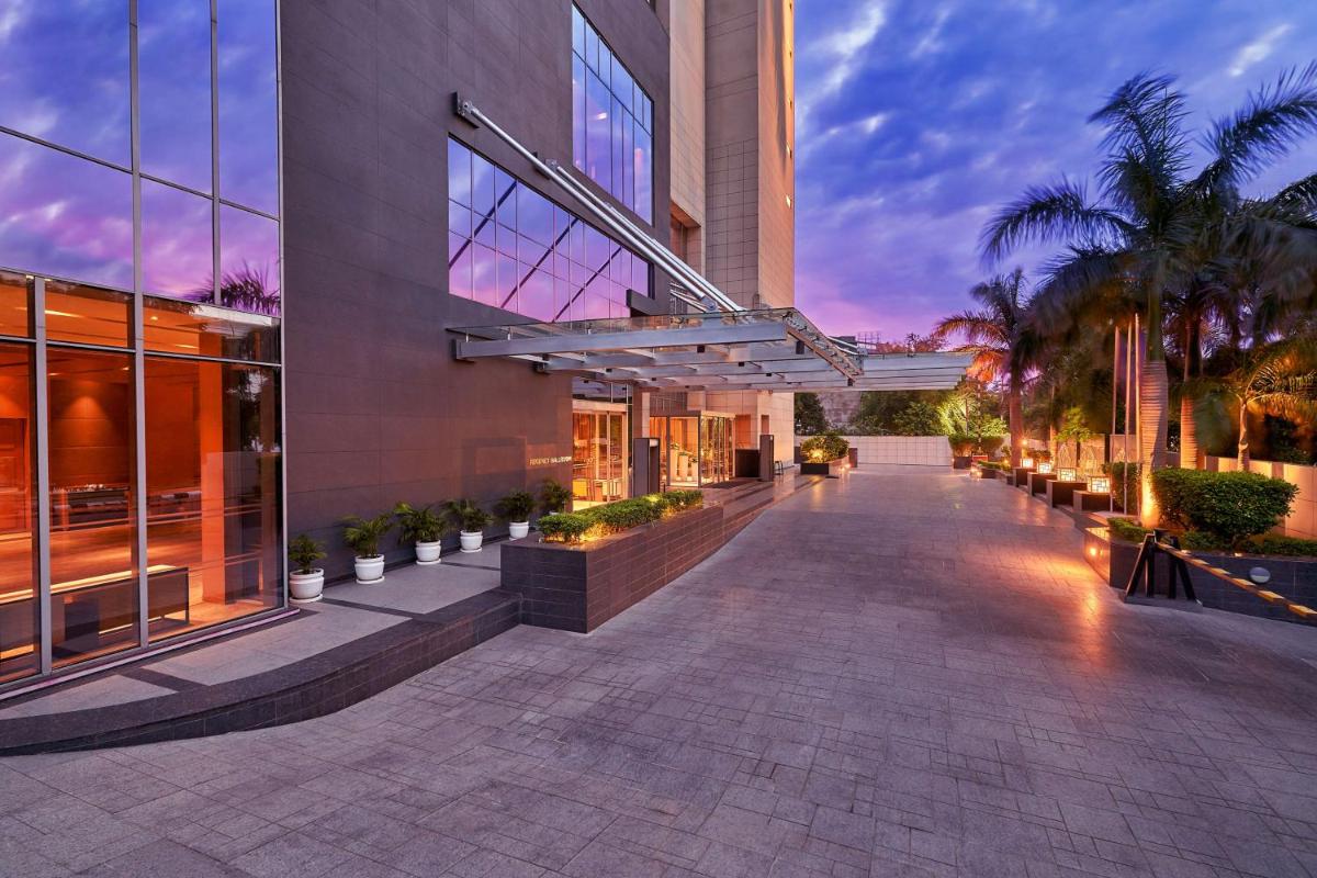 a building with a walkway in front of it at Hyatt Regency Lucknow Gomti Nagar in Lucknow