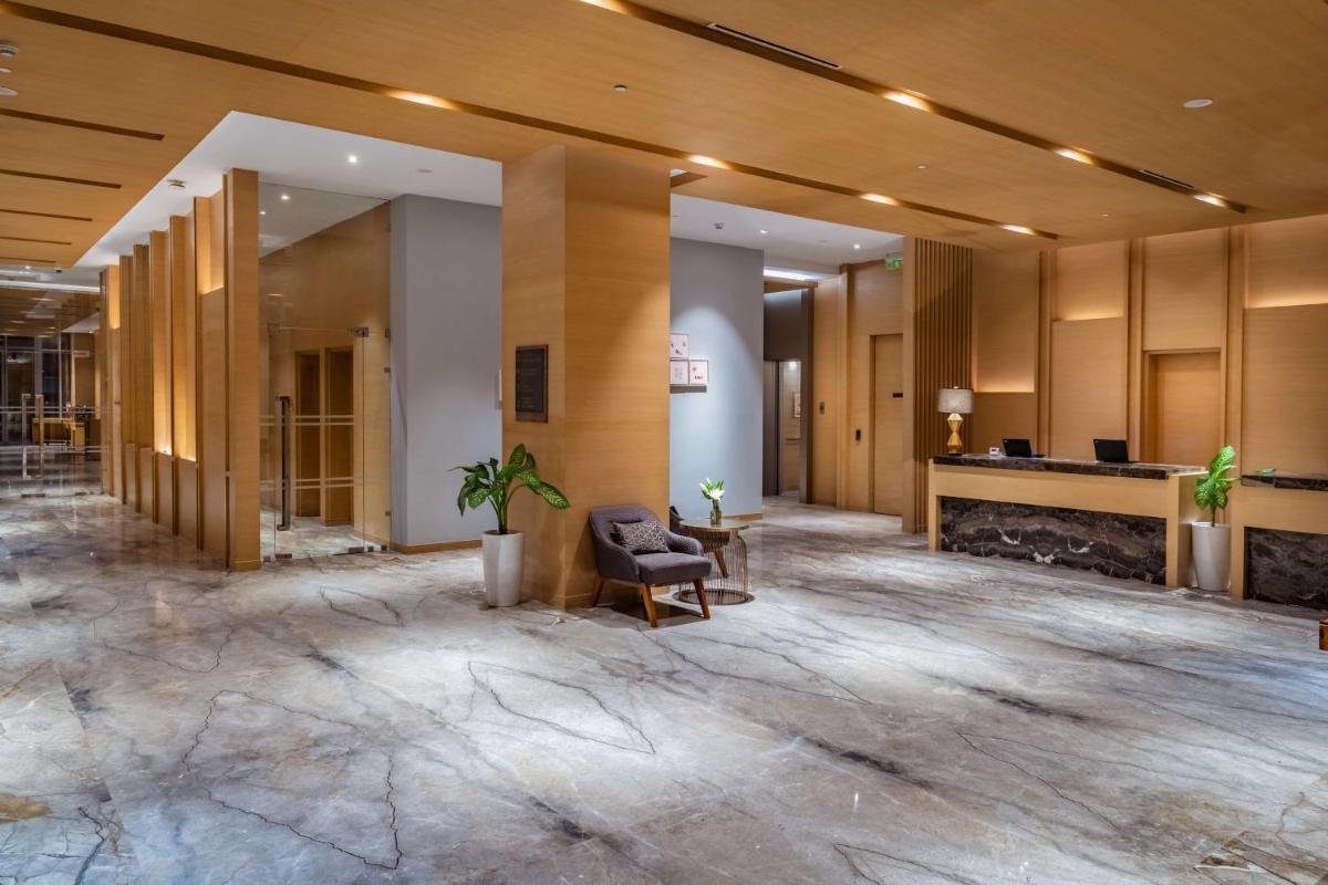 an office lobby with a chair and a desk at Hyatt Regency Lucknow Gomti Nagar in Lucknow