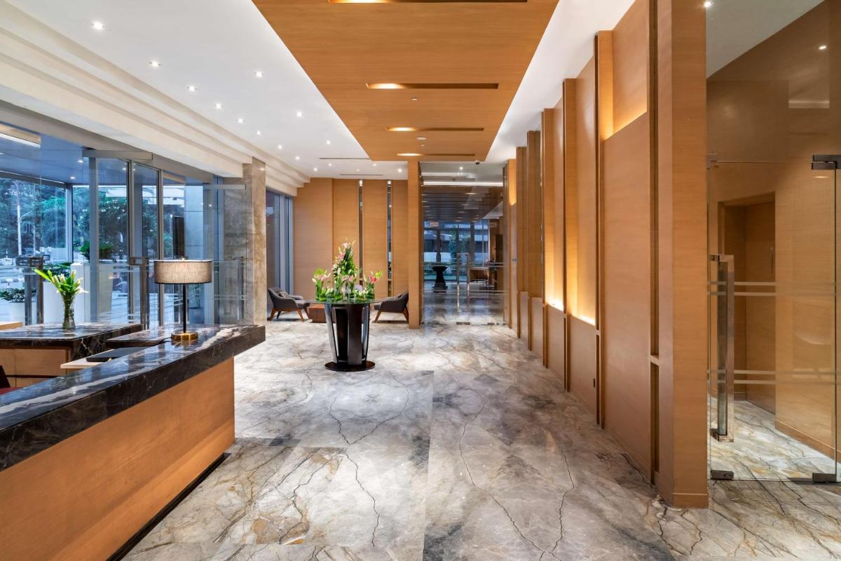a lobby of a hotel with a reception desk at Hyatt Regency Lucknow Gomti Nagar in Lucknow