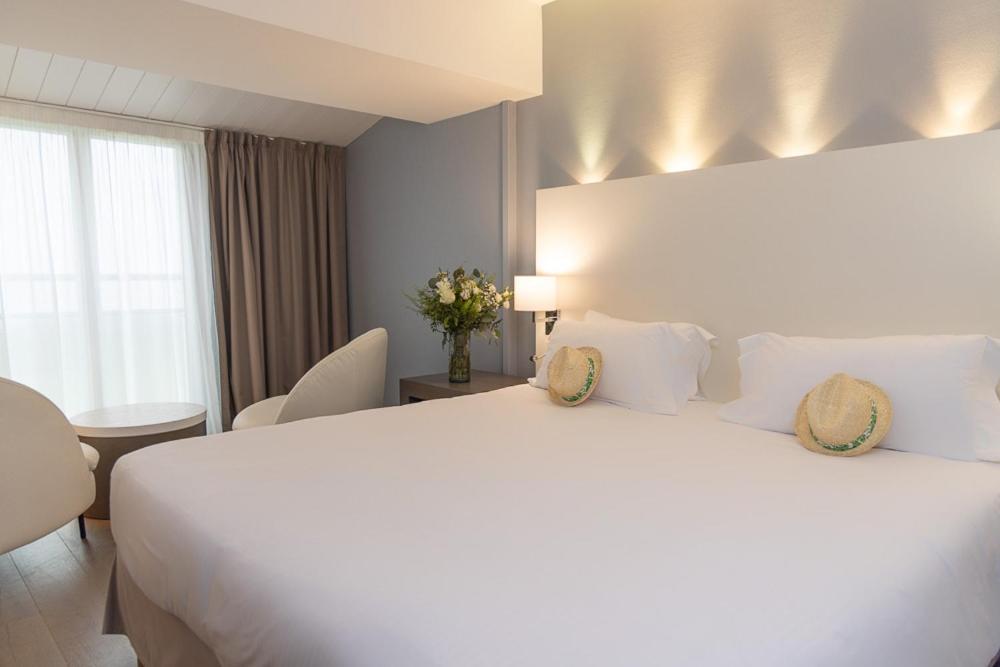 Un ou plusieurs lits dans un hébergement de l'établissement Hôtel Atalante - Relais Thalasso & Spa