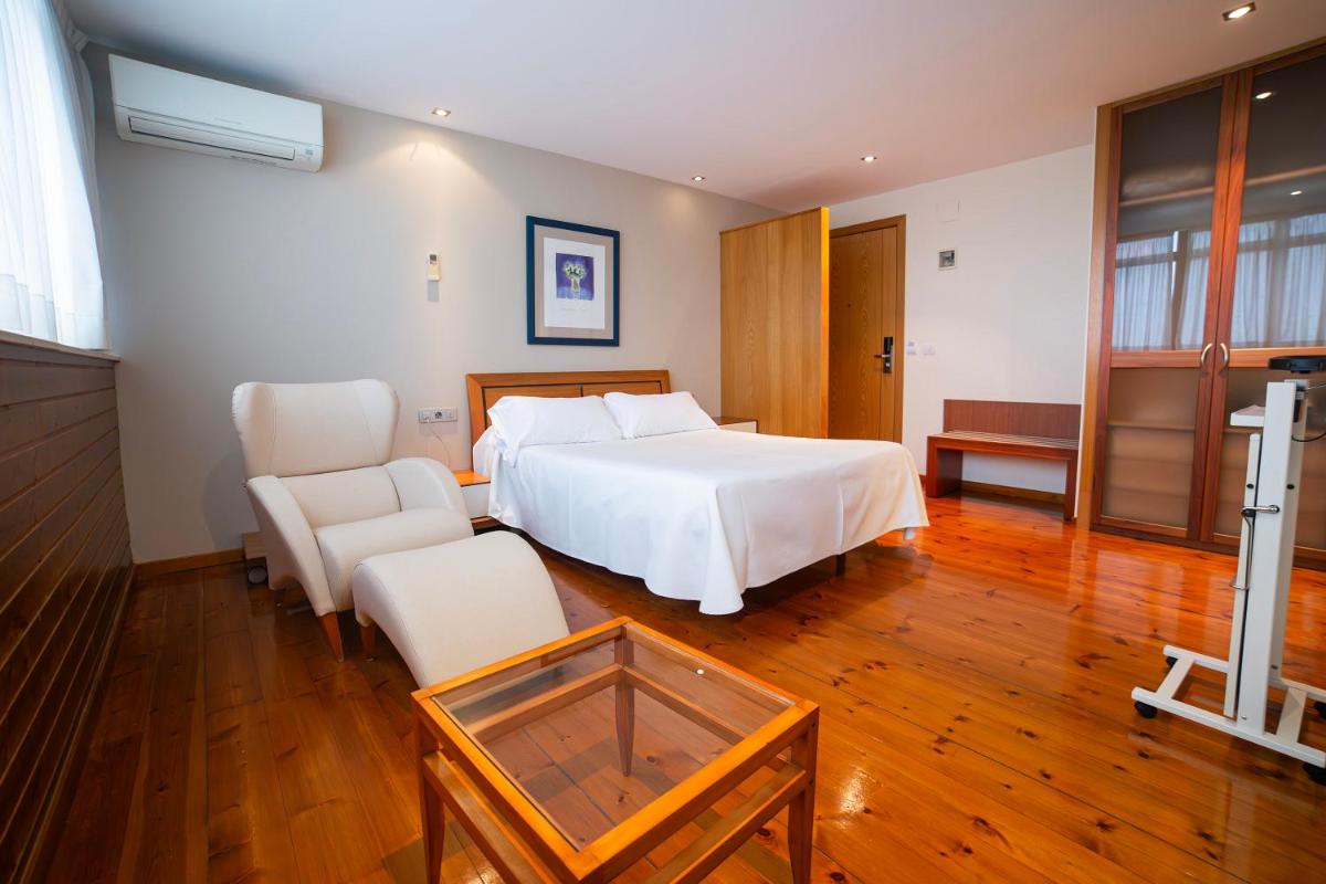 Cama o camas de una habitación en Hotel Auditorio Santiago & Spa
