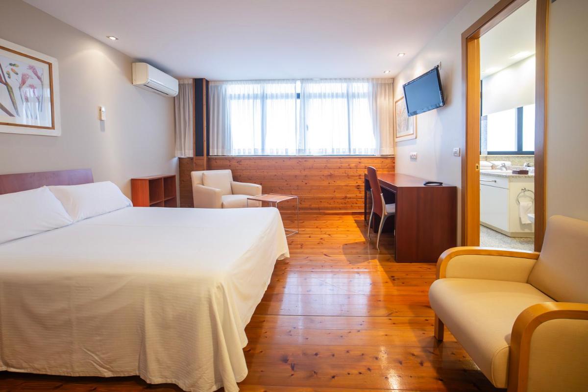 Cama o camas de una habitación en Hotel Auditorio Santiago & Spa