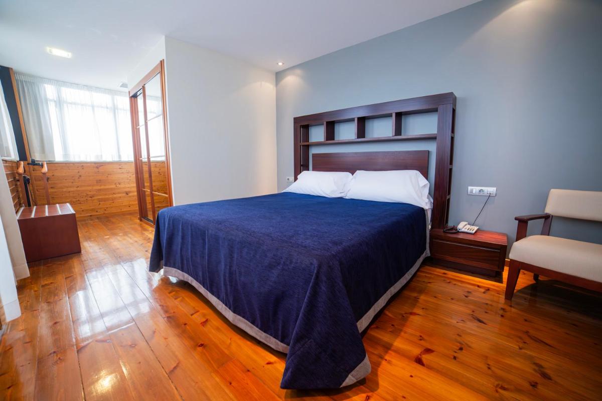Cama o camas de una habitación en Hotel Auditorio Santiago & Spa