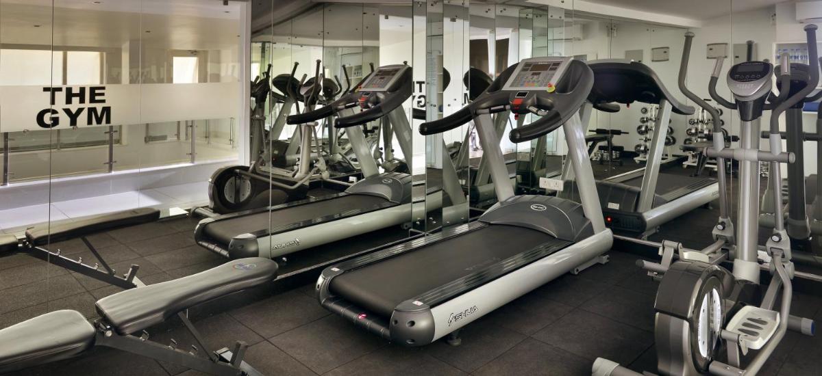 a gym with several cardio machines in a room at The Park Calangute Goa in Calangute a gym with several cardio machines in a room at The Park Calangute Goa in Calangute