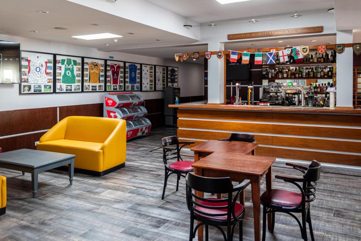 um restaurante com mesas e cadeiras e um bar em Browns Sports Resort em Vilamoura