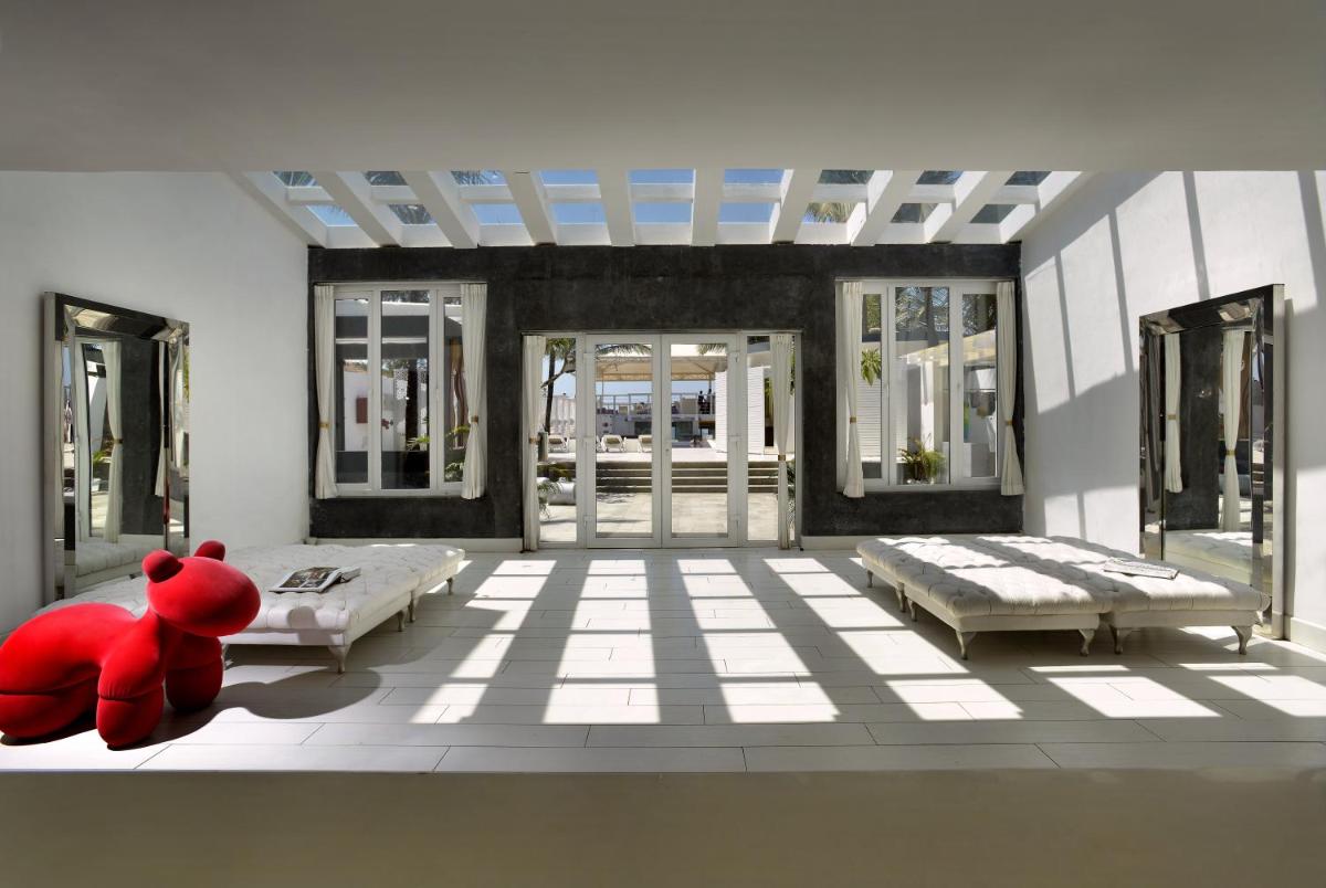a red teddy bear sitting on the floor of a room at The Park Calangute Goa in Calangute a red teddy bear sitting on the floor of a room at The Park Calangute Goa in Calangute