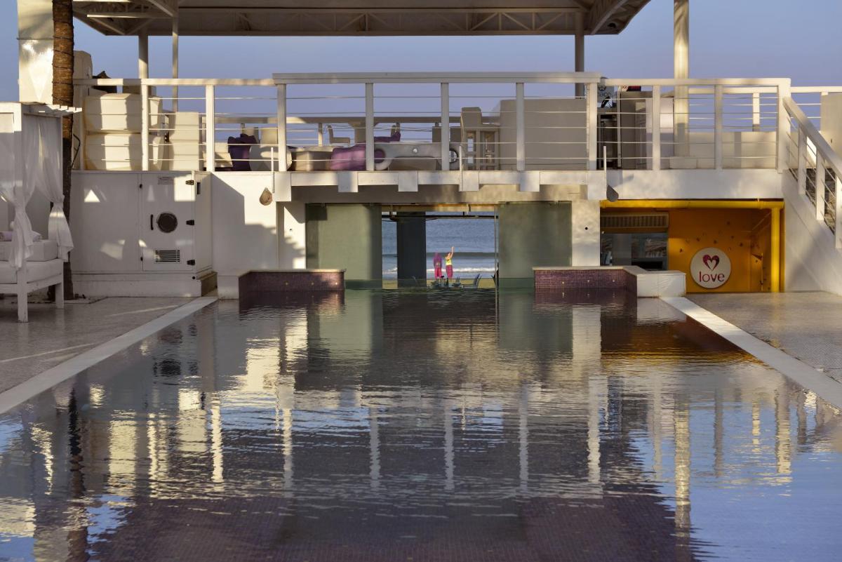 a flooded parking lot with water in front of a building at The Park Calangute Goa in Calangute a flooded parking lot with water in front of a building at The Park Calangute Goa in Calangute