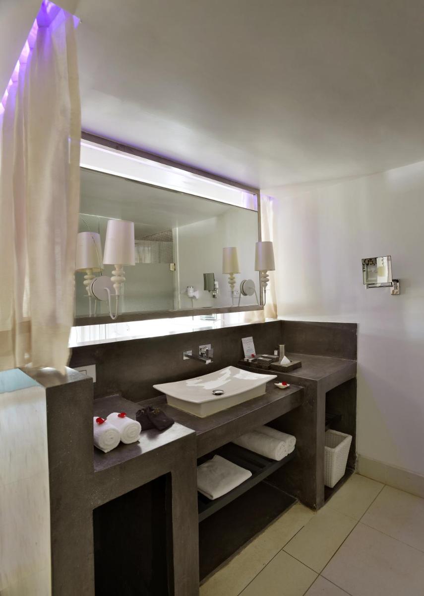 a bathroom with a sink and a large mirror at The Park Calangute Goa in Calangute a bathroom with a sink and a large mirror at The Park Calangute Goa in Calangute