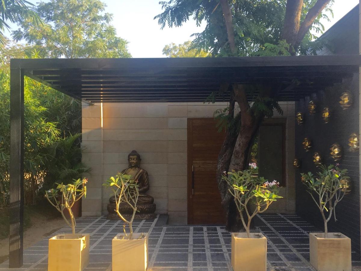 a temple with a statue in front of a building at Hotel Lakend in Udaipur