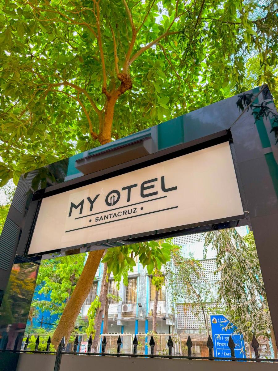 a sign for my office in front of a tree at MyOtel - Santacruz in Mumbai