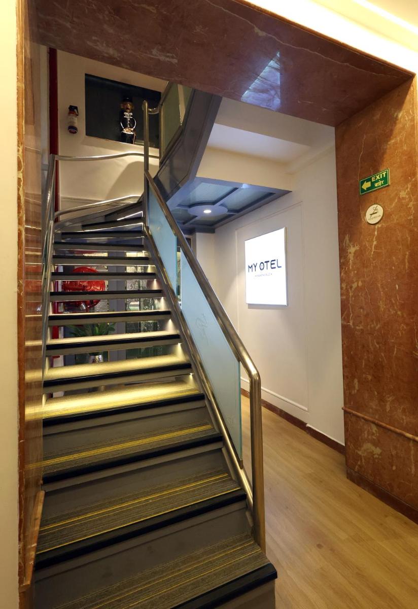 a staircase in a building with a stair case at MyOtel - Santacruz in Mumbai