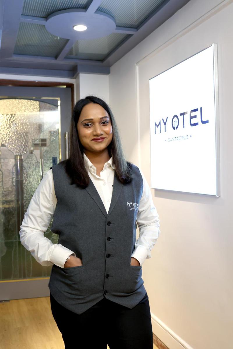 a woman in a vest standing in a room at MyOtel - Santacruz in Mumbai