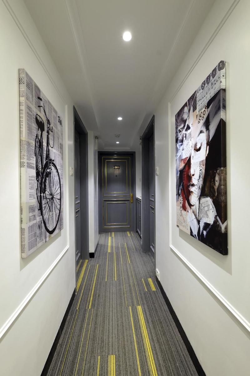 a hallway with posters on the walls of a building at MyOtel - Santacruz in Mumbai