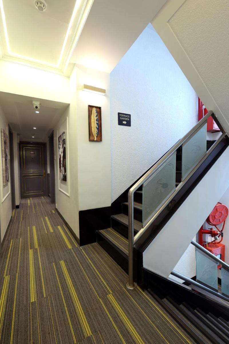 a staircase in a building with an escalator at MyOtel - Santacruz in Mumbai