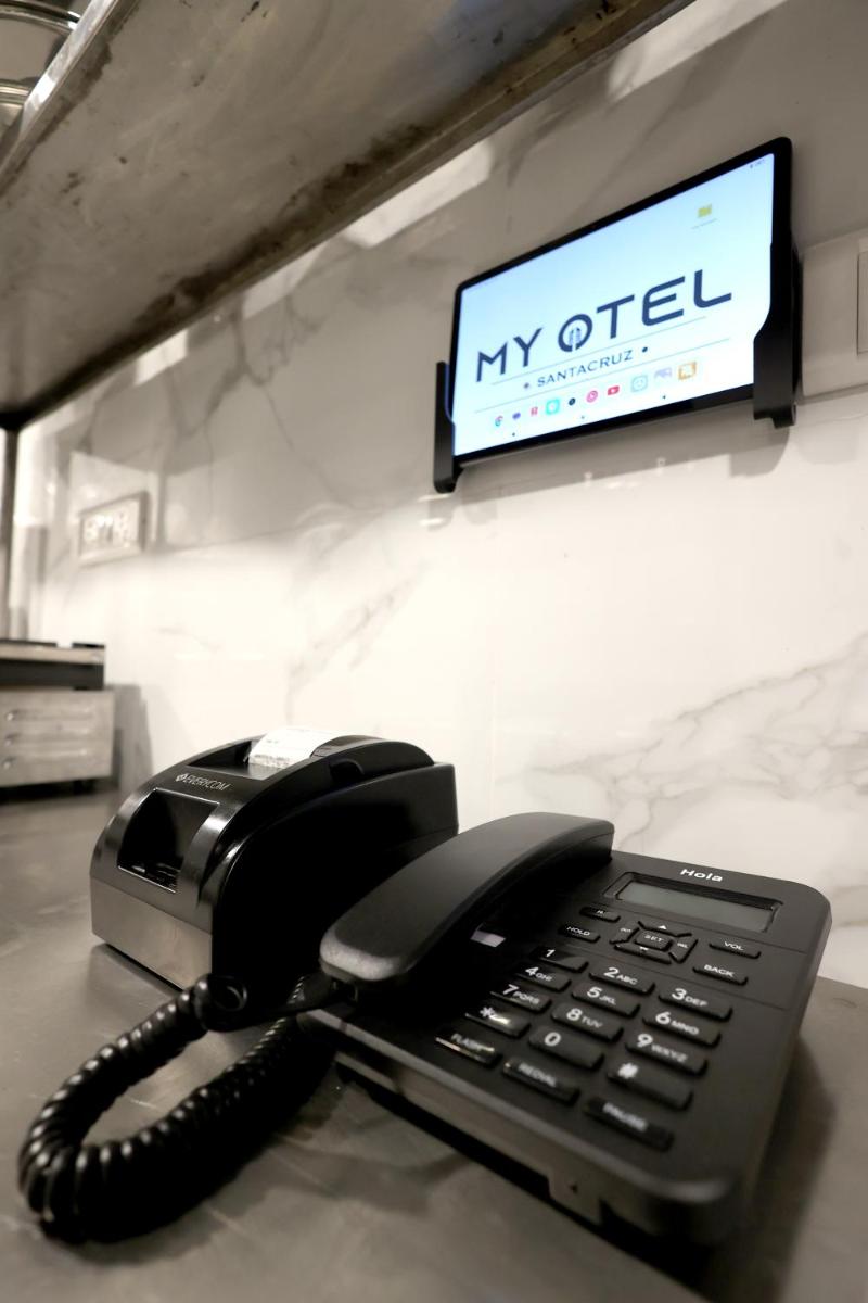a black office phone sitting on a desk at MyOtel - Santacruz in Mumbai