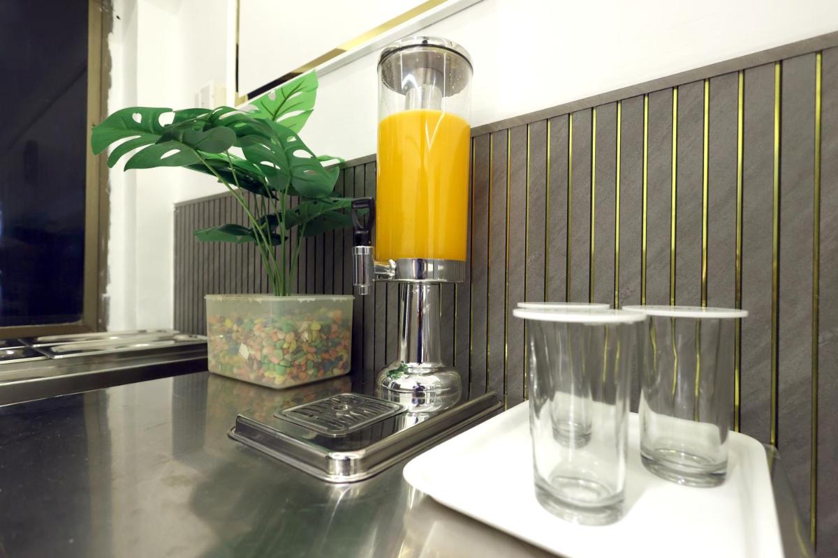 a table with a blender and a lamp on it at MyOtel - Santacruz in Mumbai