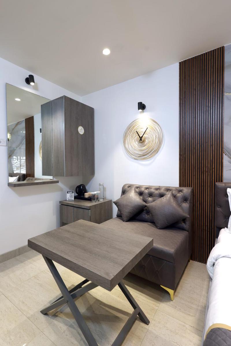 a living room with a couch and a table at MyOtel - Santacruz in Mumbai