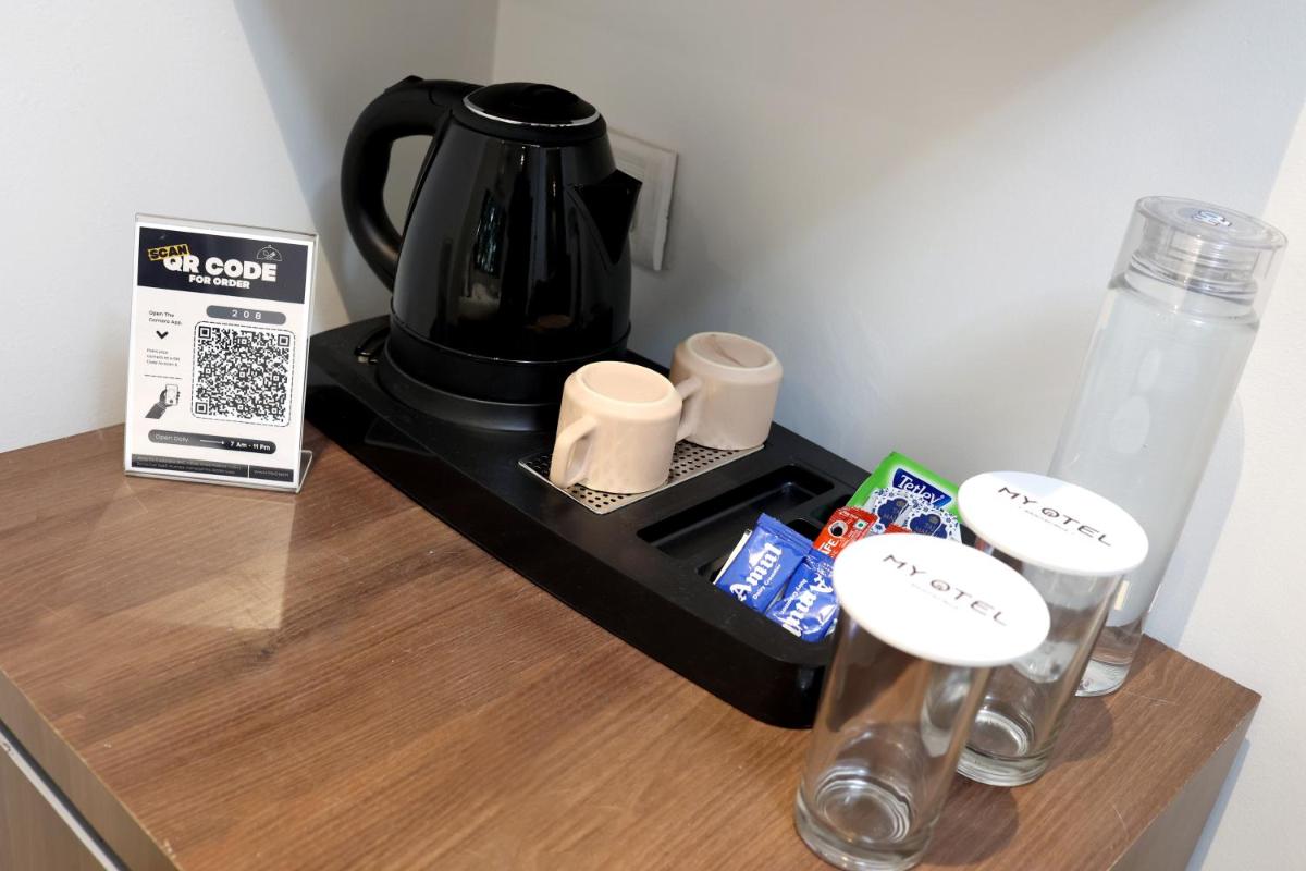 a coffee maker sitting on top of a counter at MyOtel - Santacruz in Mumbai