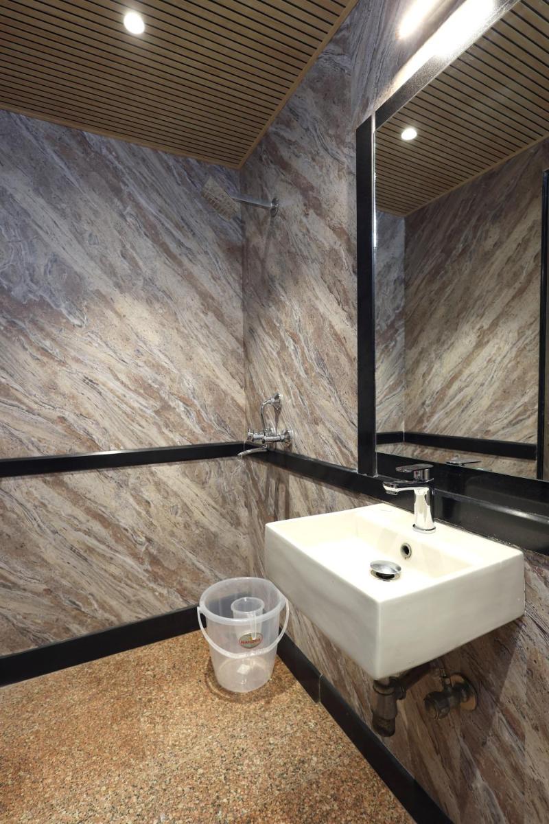 a bathroom with a sink and a mirror at MyOtel - Santacruz in Mumbai