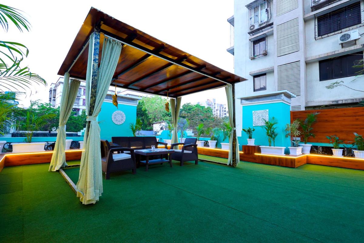 a patio with a table and chairs on a balcony at MyOtel - Santacruz in Mumbai