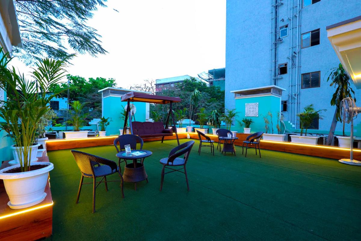 a group of chairs and tables on a patio at MyOtel - Santacruz in Mumbai