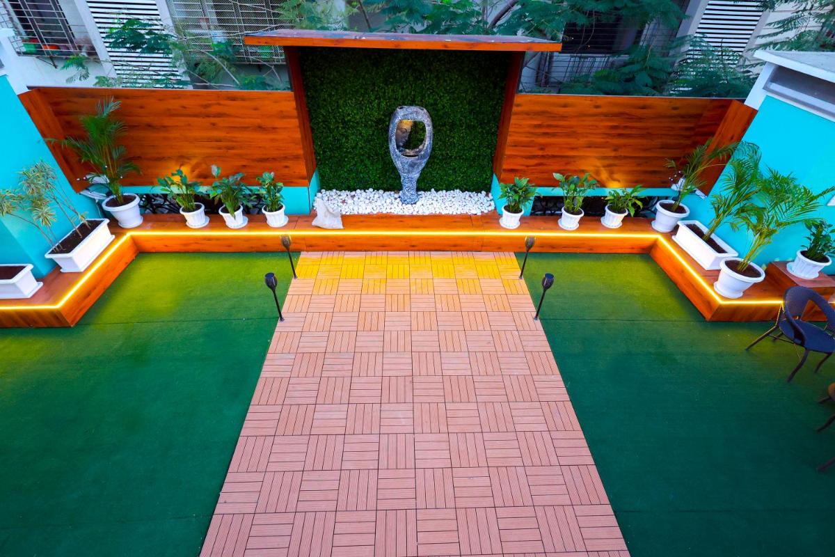 a garden with plants and a fountain in a building at MyOtel - Santacruz in Mumbai