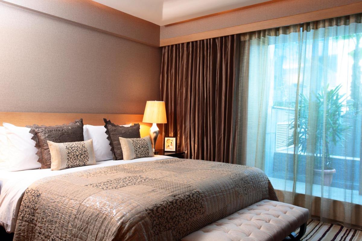 a bedroom with a large bed and a large window at The Leela Ambience Gurugram Hotel & Residences - The Luxury Urban Sanctuary in Gurgaon