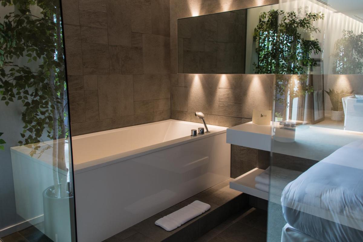 Un ou plusieurs lits dans un hébergement de l'établissement Bdesign & Spa