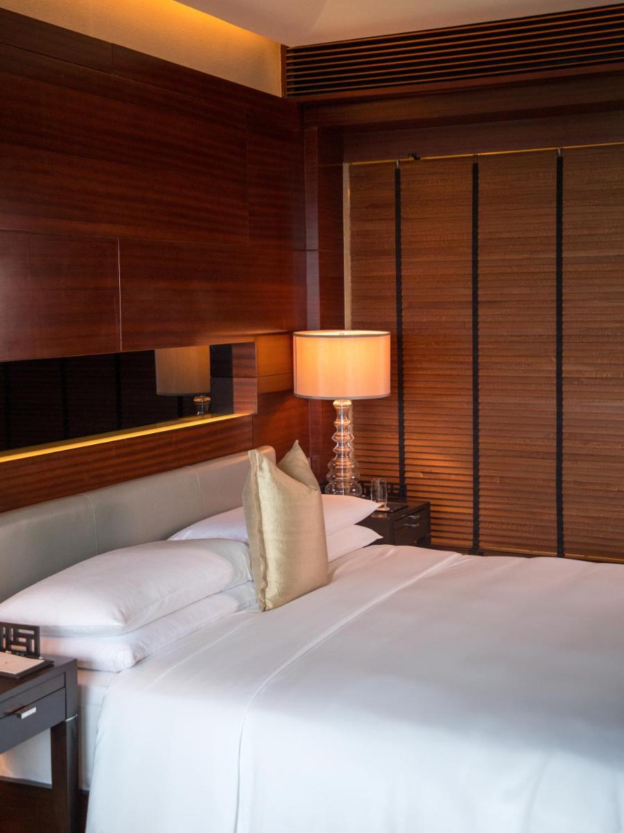 a bedroom with two white beds and a lamp at The Leela Ambience Gurugram Hotel & Residences - The Luxury Urban Sanctuary in Gurgaon