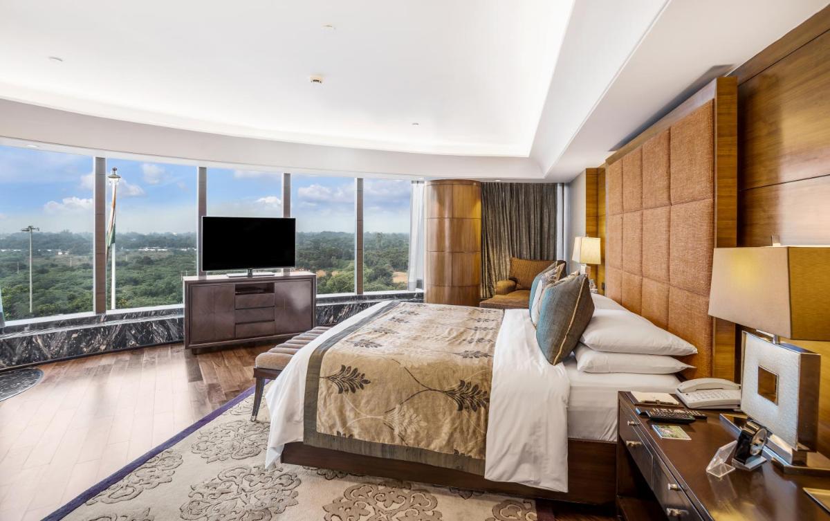 a hotel room with a bed and a television at The Leela Ambience Gurugram Hotel & Residences - The Luxury Urban Sanctuary in Gurgaon