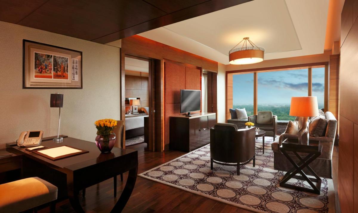 a living room with a desk and a living room at The Leela Ambience Gurugram Hotel & Residences - The Luxury Urban Sanctuary in Gurgaon