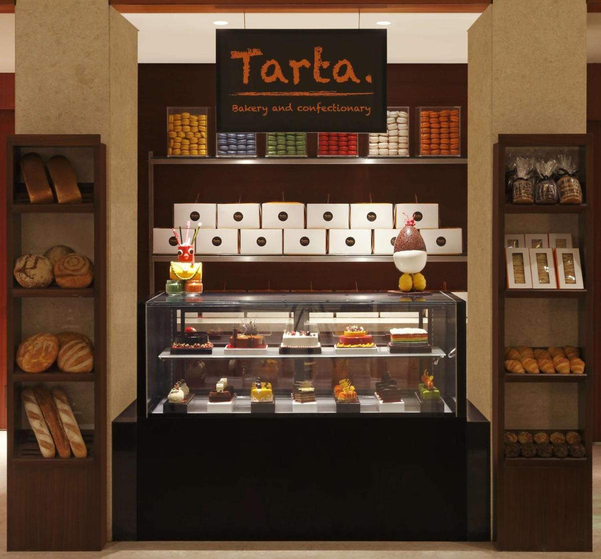 a bakery display case with different types of pastries at DoubleTree by Hilton-Pune Chinchwad in Pune