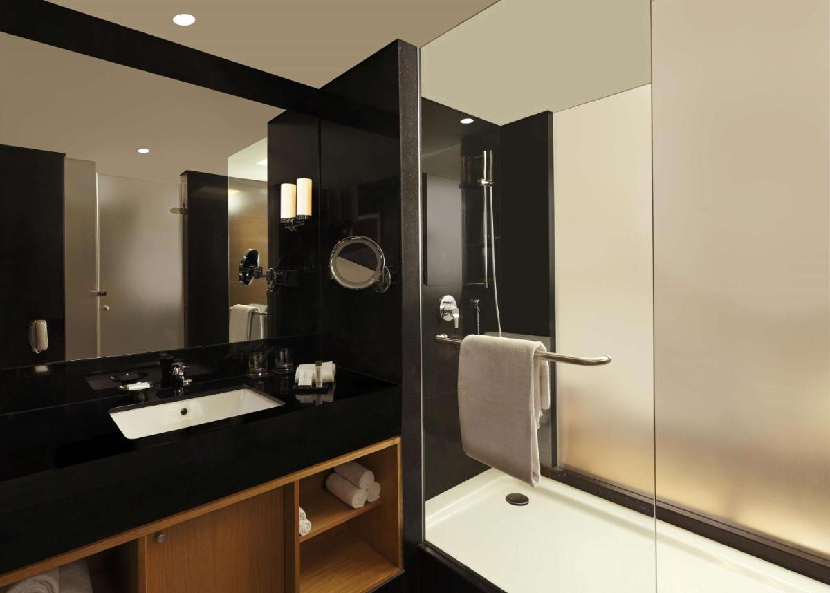a bathroom with a sink and a shower at DoubleTree by Hilton-Pune Chinchwad in Pune