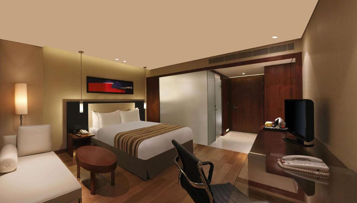 a hotel room with a bed and a desk at DoubleTree by Hilton-Pune Chinchwad in Pune