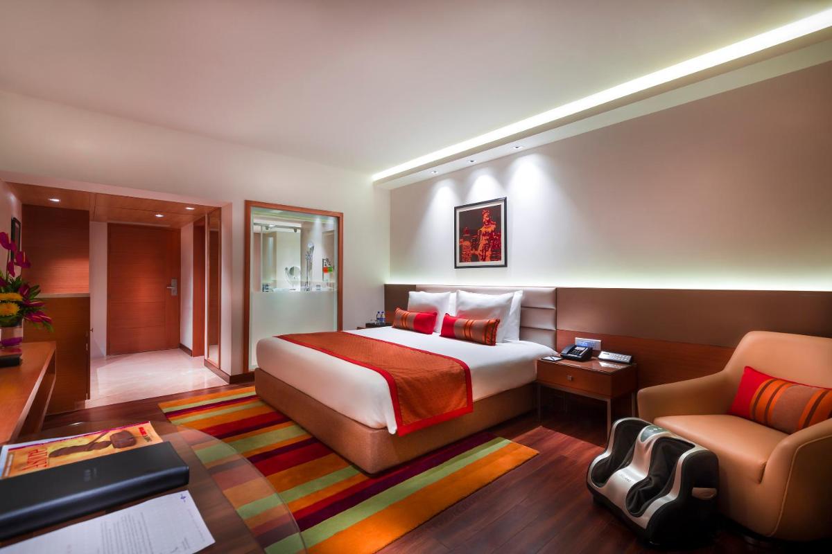 a hotel room with a bed and a couch at Grand Chennai by GRT Hotels in Chennai