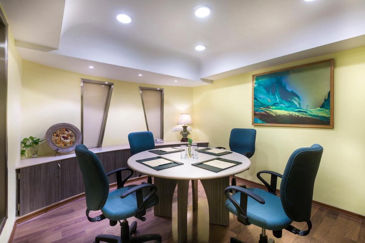 a meeting room with a table and chairs at Grand Chennai by GRT Hotels in Chennai