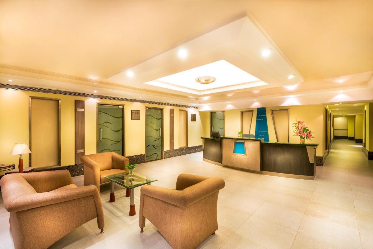 a lobby of a hotel with chairs and a table at Grand Chennai by GRT Hotels in Chennai